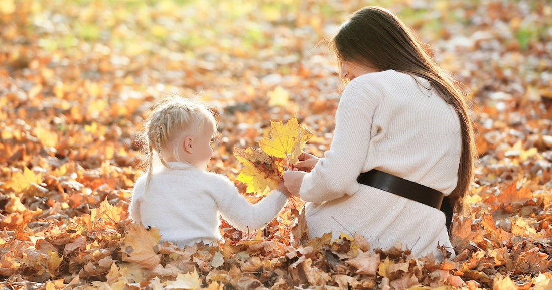 Relaxed woman enjoying fresh air outdoors in crisp fall weather, embracing autumn self care.