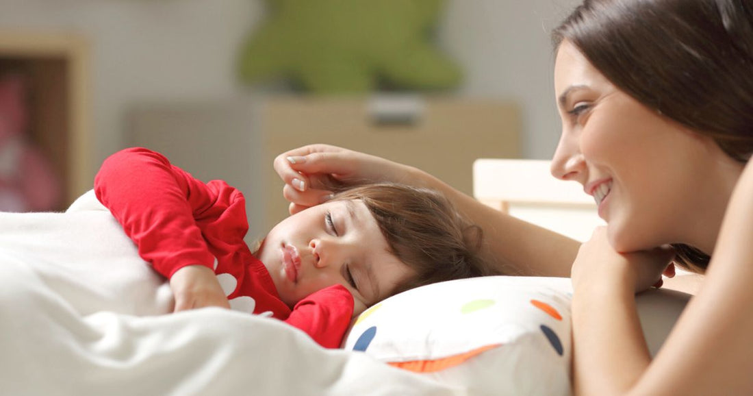 Mother watching over her baby sleeping peacefully in a toddler bed, creating a safe and comforting bedroom environment that supports healthy sleep and nighttime security.