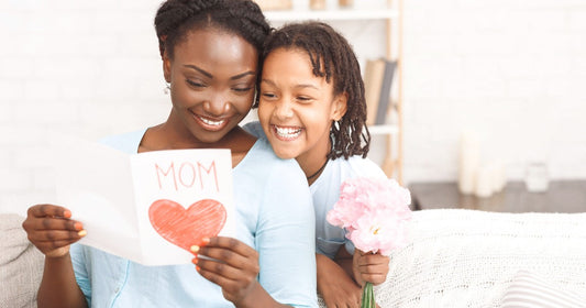 Mom reading a heartfelt Mother’s Day letter from her child, celebrating family love, appreciation, and emotional bonding during a special moment together.