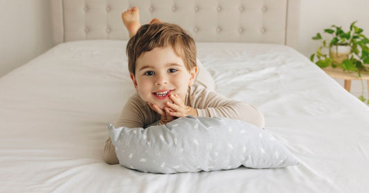 Toddler lying comfortably on a KeaBabies toddler pillow for restful sleep