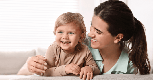 Mother building connection through play with her toddler before introducing the school routine.
