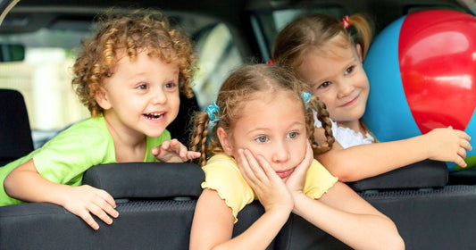 Three excited toddlers in the car, ready for an unforgettable road trip.
