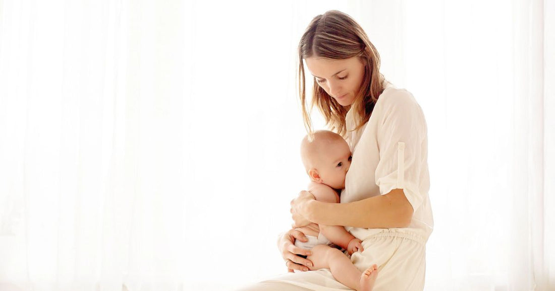 Tender moment of a mom breastfeeding her baby, capturing the quiet bond between them.