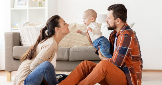 Mom and dad bonding with their baby in the living room