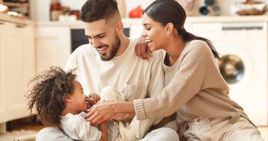Happy family of mother, father, and son laughing and playing together.