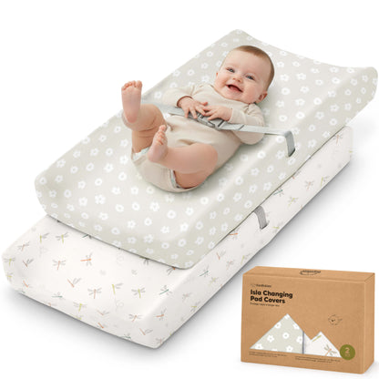 Isla changing pad covers, 2-pack, shown with a baby lying on top of the padded changing mat. 31252301316282